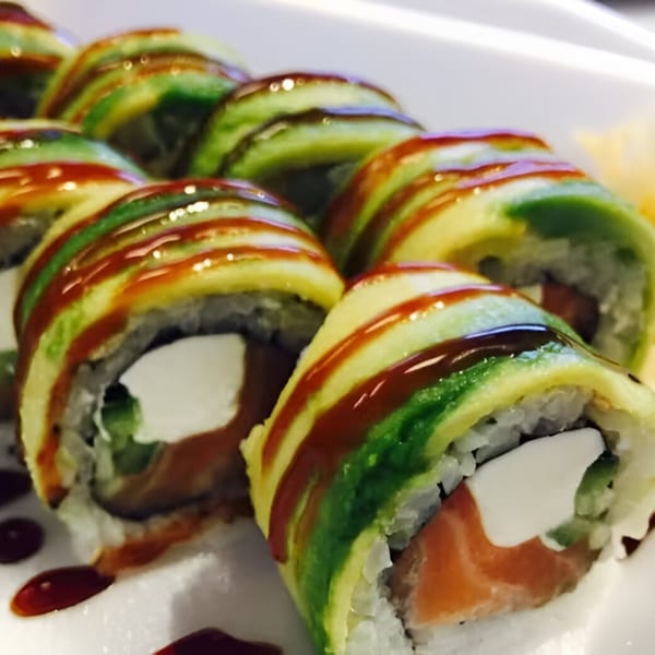 Close-up of Koto Teriyaki & Sushi's Dragon Roll, with avocado, salmon, and cream cheese.