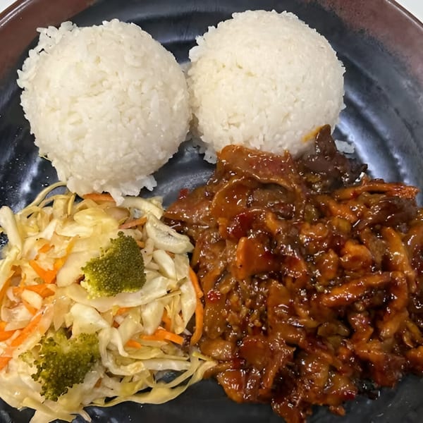 Koto Teriyaki & Sushi's chicken teriyaki with two scoops of white rice and a side salad.